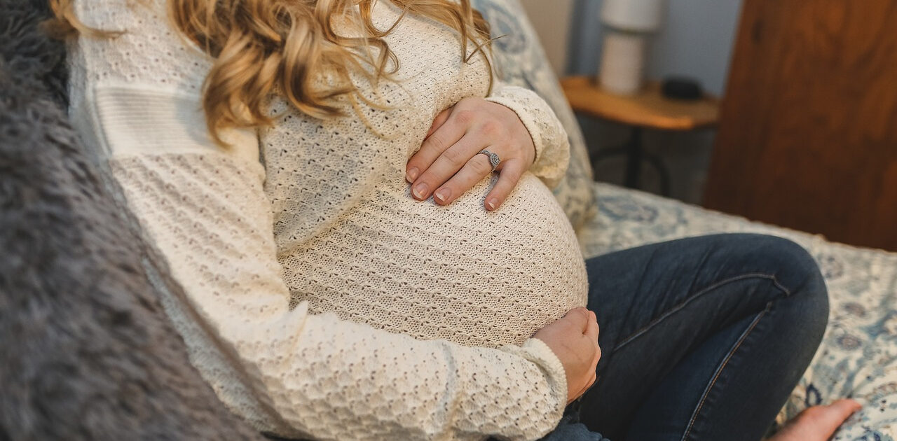 Pregnant Lady Sitting Up On Bed